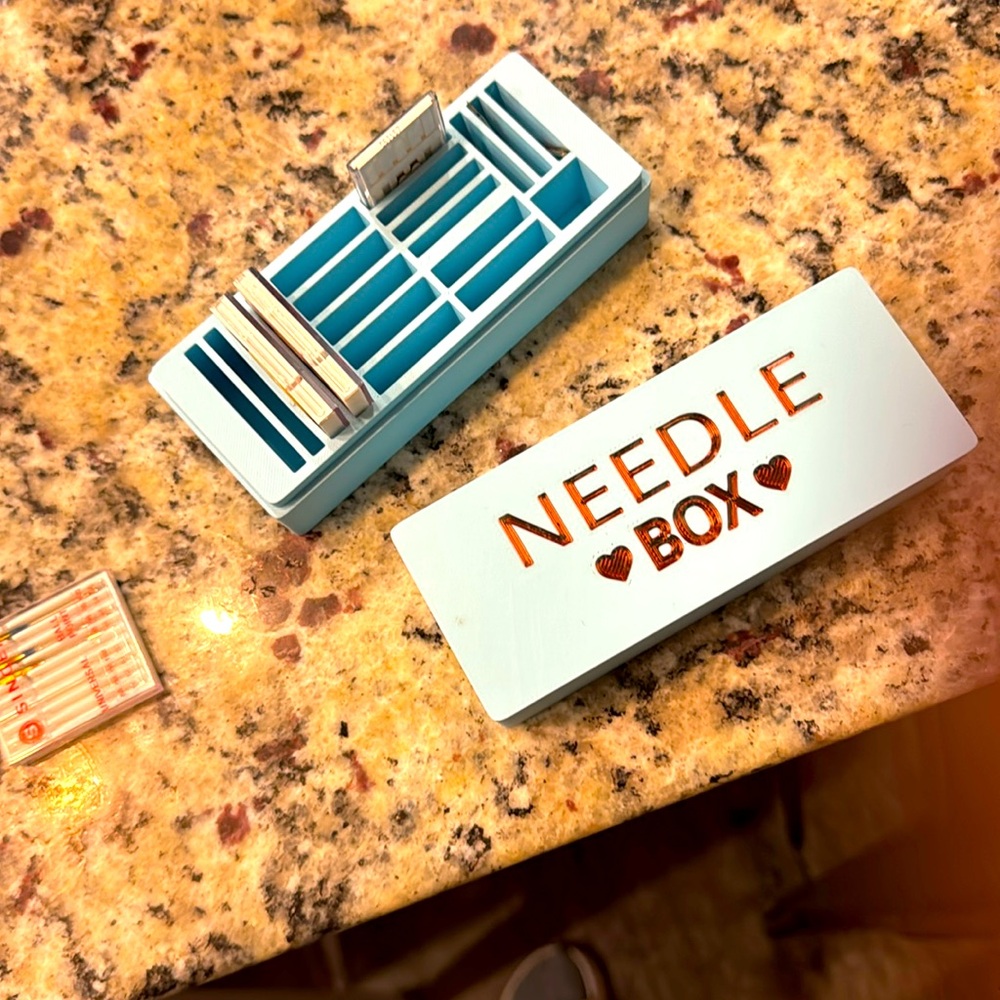 Blue sewing machine needle storage box